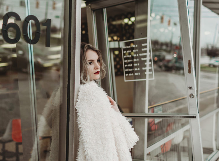 girl standing at laundromat door