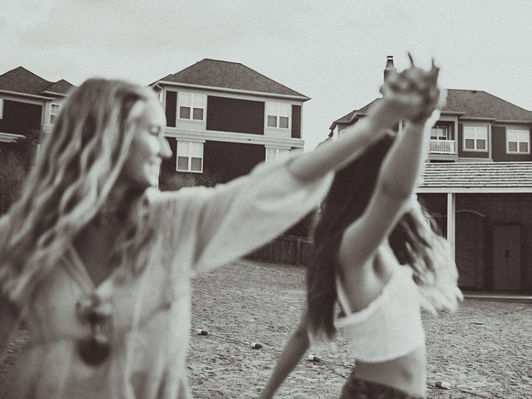 two girls dancing on the beach