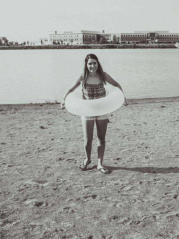 girl on beach with float around her waist