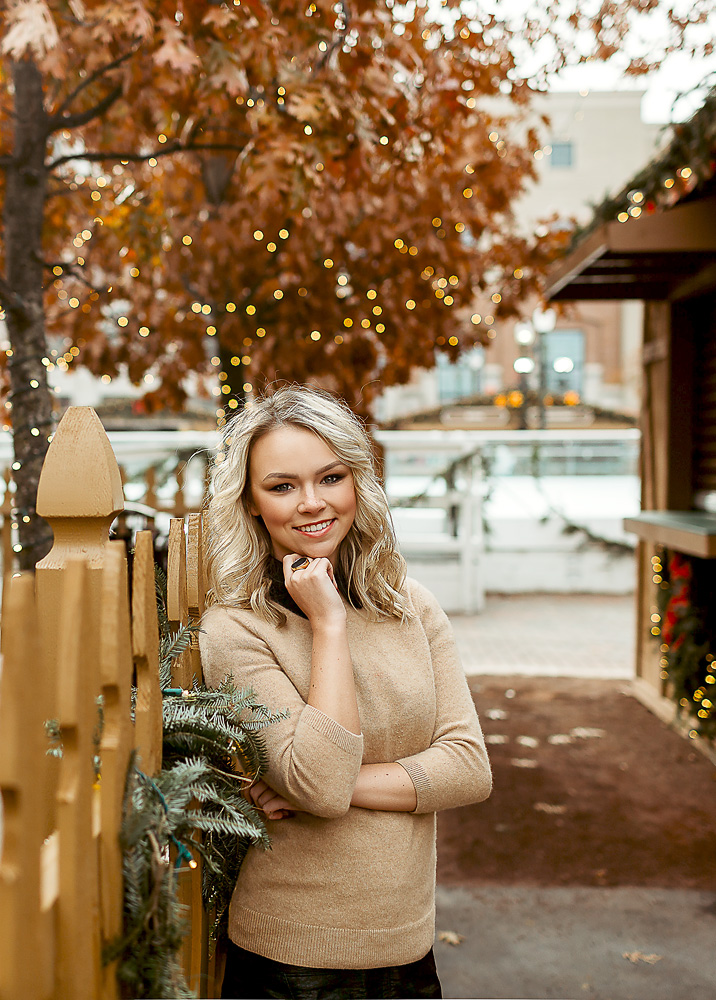 a highschool senior posing for winter portraits in Carmel Indiana