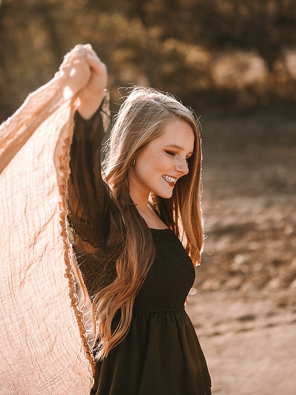 freckled face girl dancing in green dress