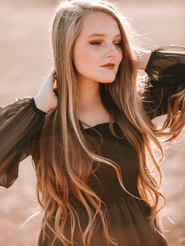 freckled face girl dancing in green dress