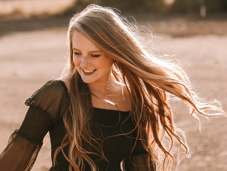 freckled face girl dancing in green dress