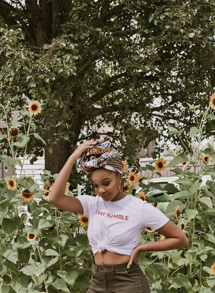 woman standing in front of a patch of sunflowers