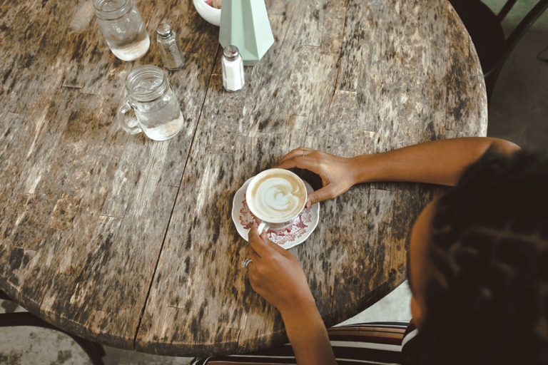 cup of coffee on wood table with heart graphic