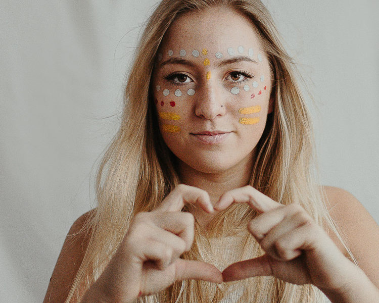 high school girl with face colorful face paint