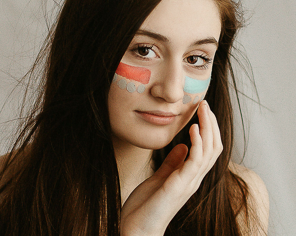 high school girl with face colorful face paint