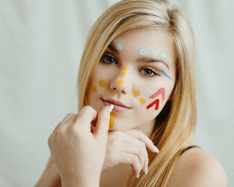 high school girl with face colorful face paint