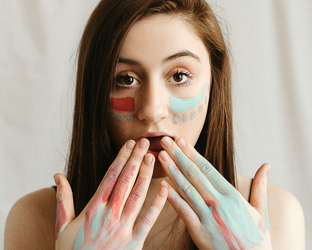 high school girl with face colorful face paint