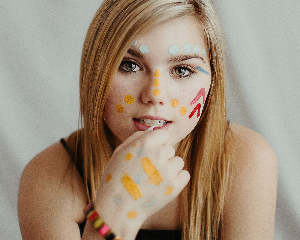 high school girl with face colorful face paint