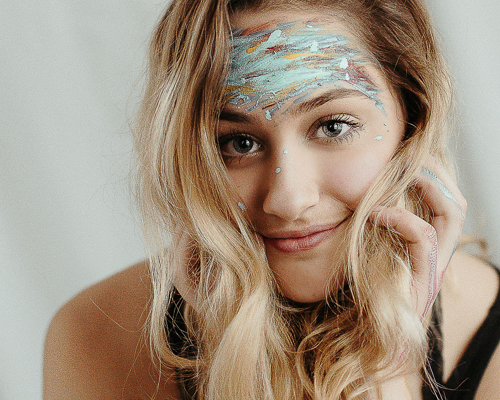 high school girl with face colorful face paint