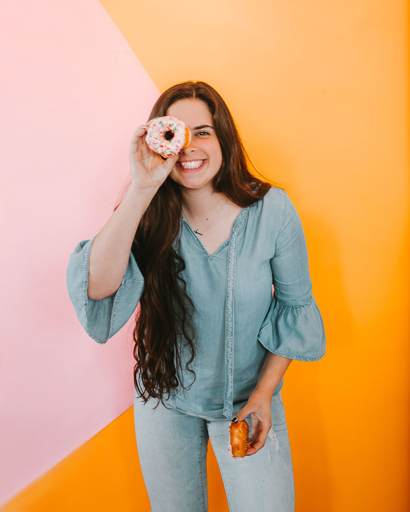pretty young girl holding a donut
