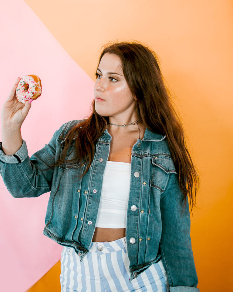 girls holding donuts in hand