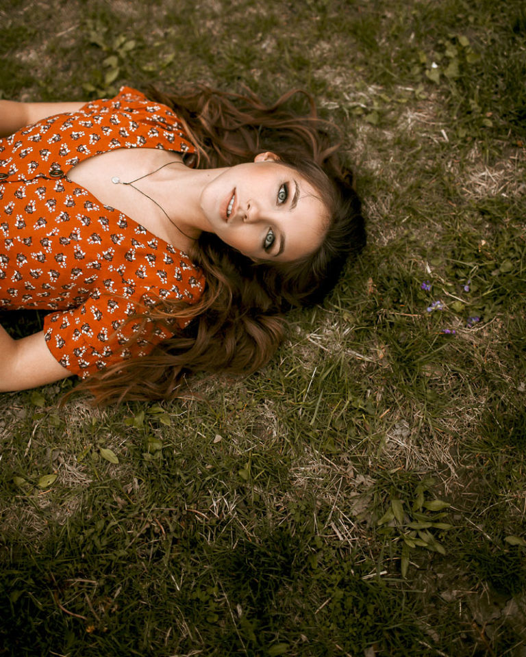 girl laying on grass looking up