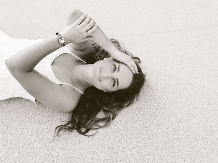 blacka nd white photo of girl laying on her baCK