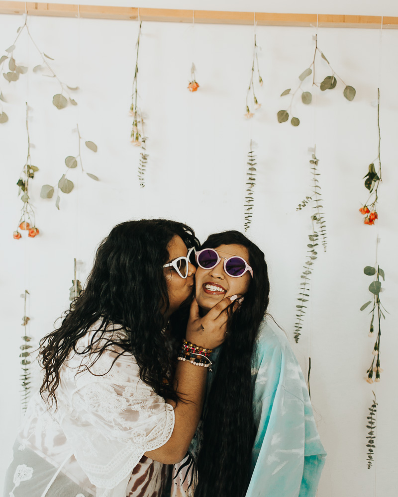 disco themed fashion with one girl kissing another playfully